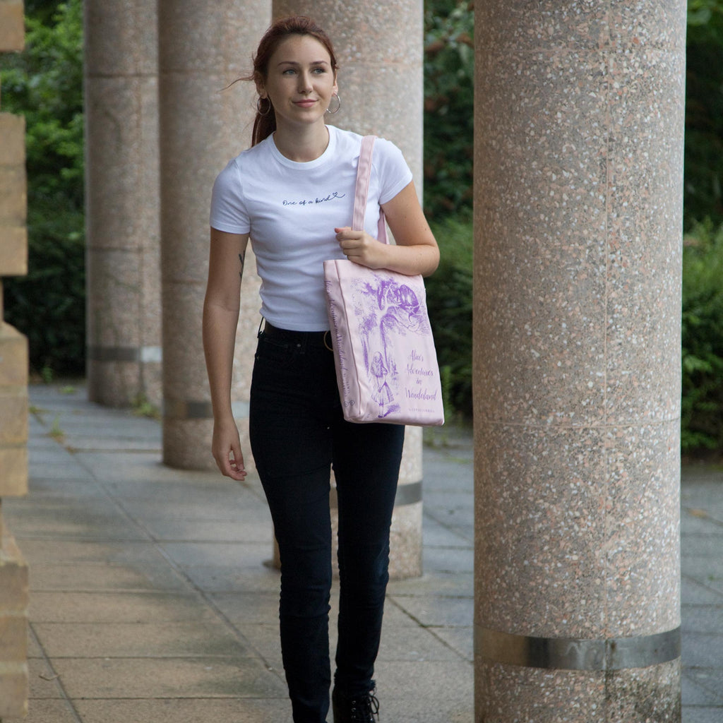 Alice's Adventures in Wonderland Pink Tote Bag by Lewis Carroll featuring Alice and Cheshire Cat design, by Well Read Co. - Model