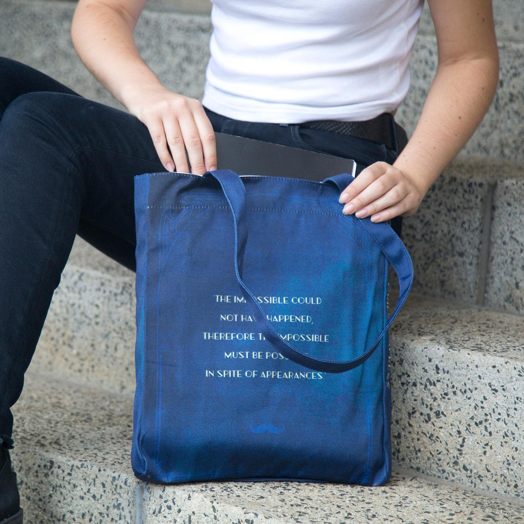 The Murder on the Orient Express Blue Tote Bag by Agatha Christie featuring Steam Train design, by Well Read Co. - Model Sitting with Bag