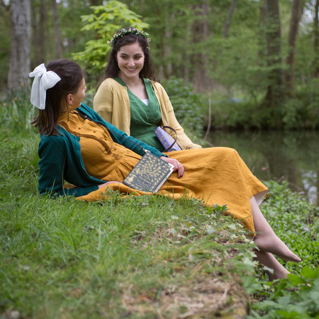 Book-shaped Pride and Prejudice Green Crossbody Purse by Jane Austen with Gold Peacock Feather design, by Well Read Co - Two Girls Sitting