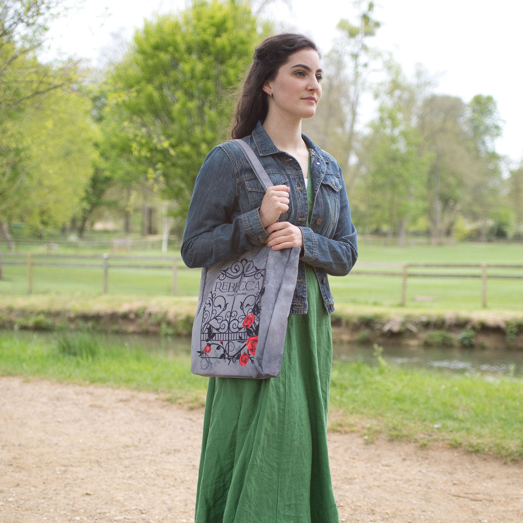 Rebecca Grey Tote Bag by Daphne du Maurier featuring Ornate Gate covered in Roses design, by Well Read Co. - Model Standing