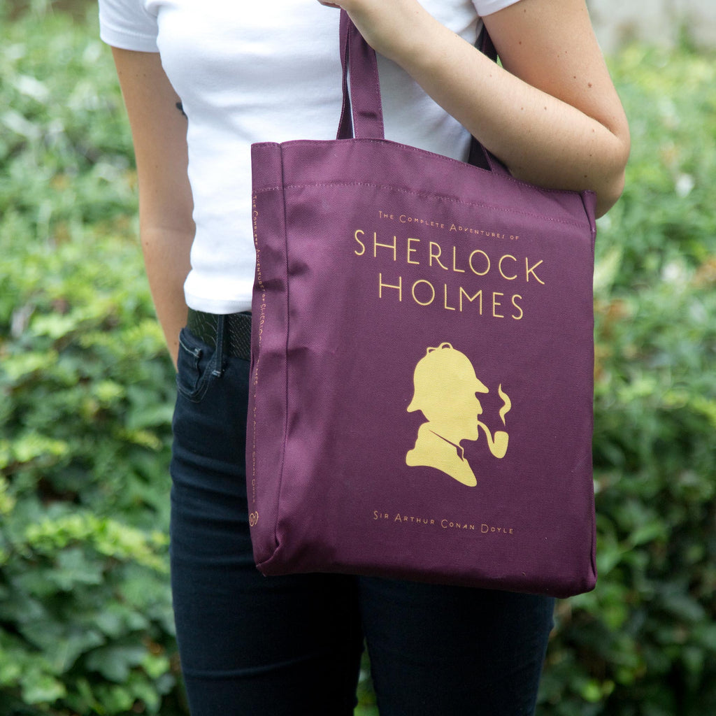 Sherlock Holmes Burgundy Tote Bag by Arthur Conan Doyle featuring Sherlock Holmes Silhouette design, by Well Read Co. - Model Standing