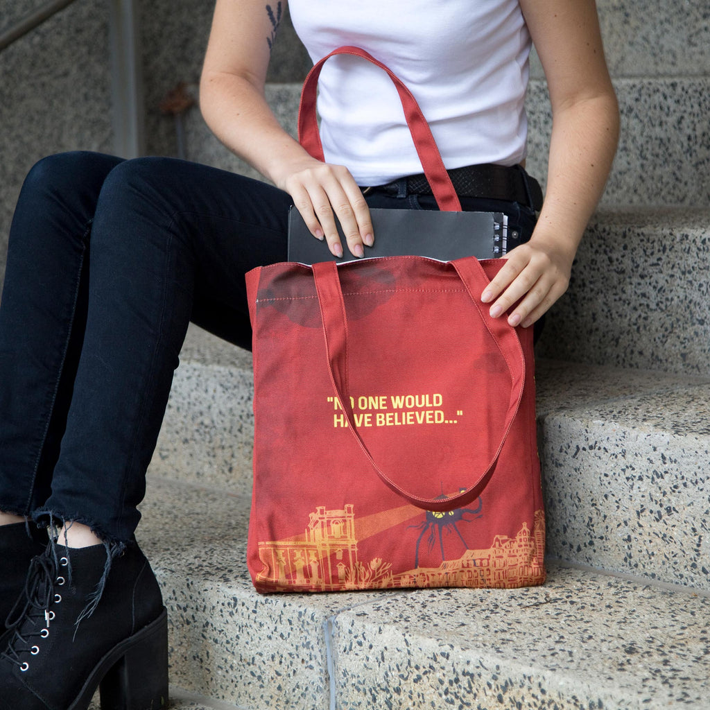 The War of the Worlds Red Tote Bag by H.G. Wells featuring Alien Tripods design, by Well Read Co. - Girl Sitting