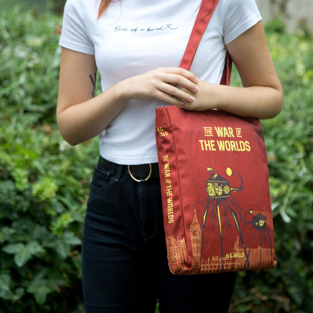 The War of the Worlds Red Tote Bag by H.G. Wells featuring Alien Tripods design, by Well Read Co. - Girl Standing with Bag